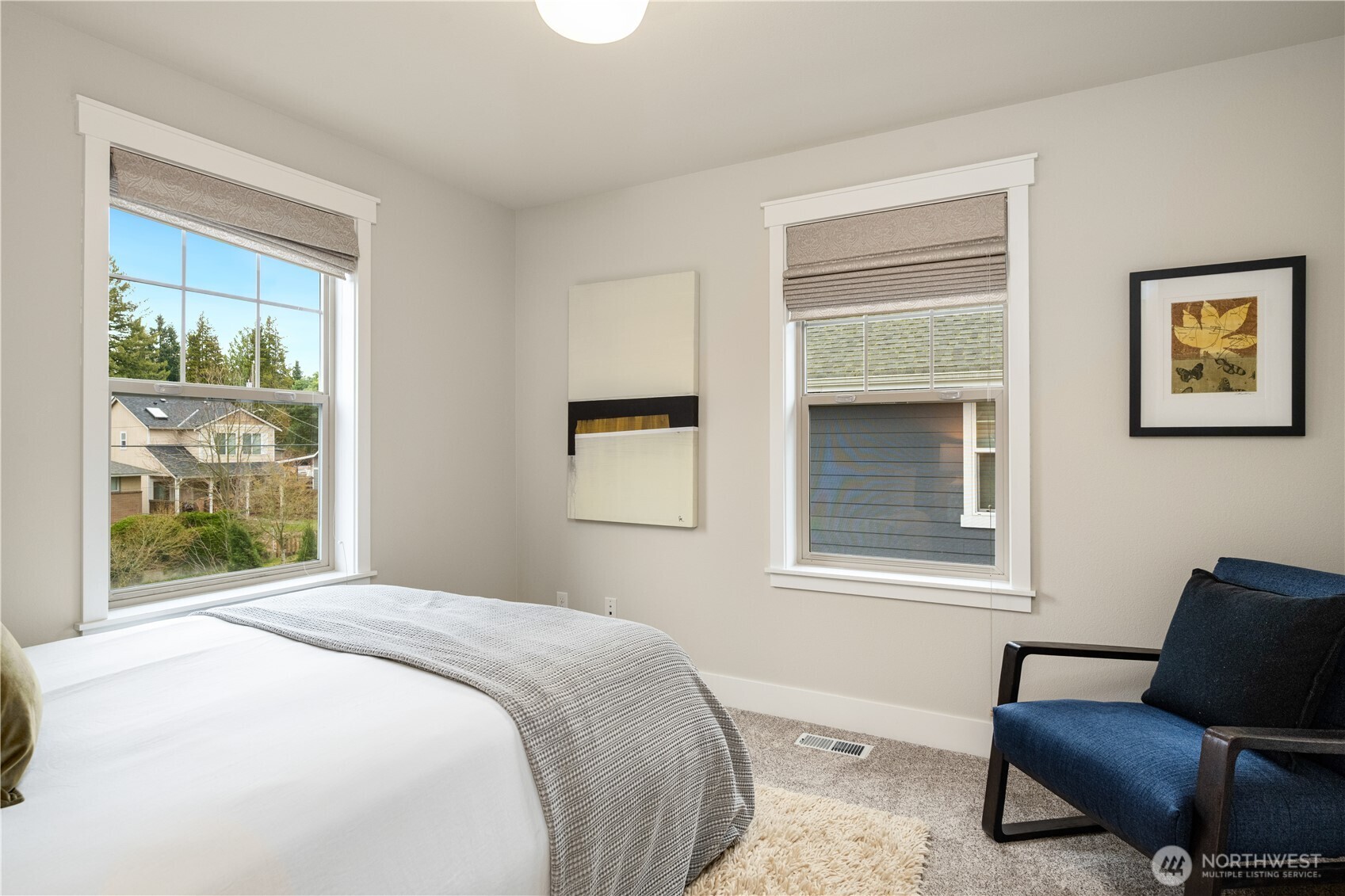 7709 17th Avenue Southwest Seattle, WA 98106 - Photo 28 of 37 a bedroom with a bed and wooden floor