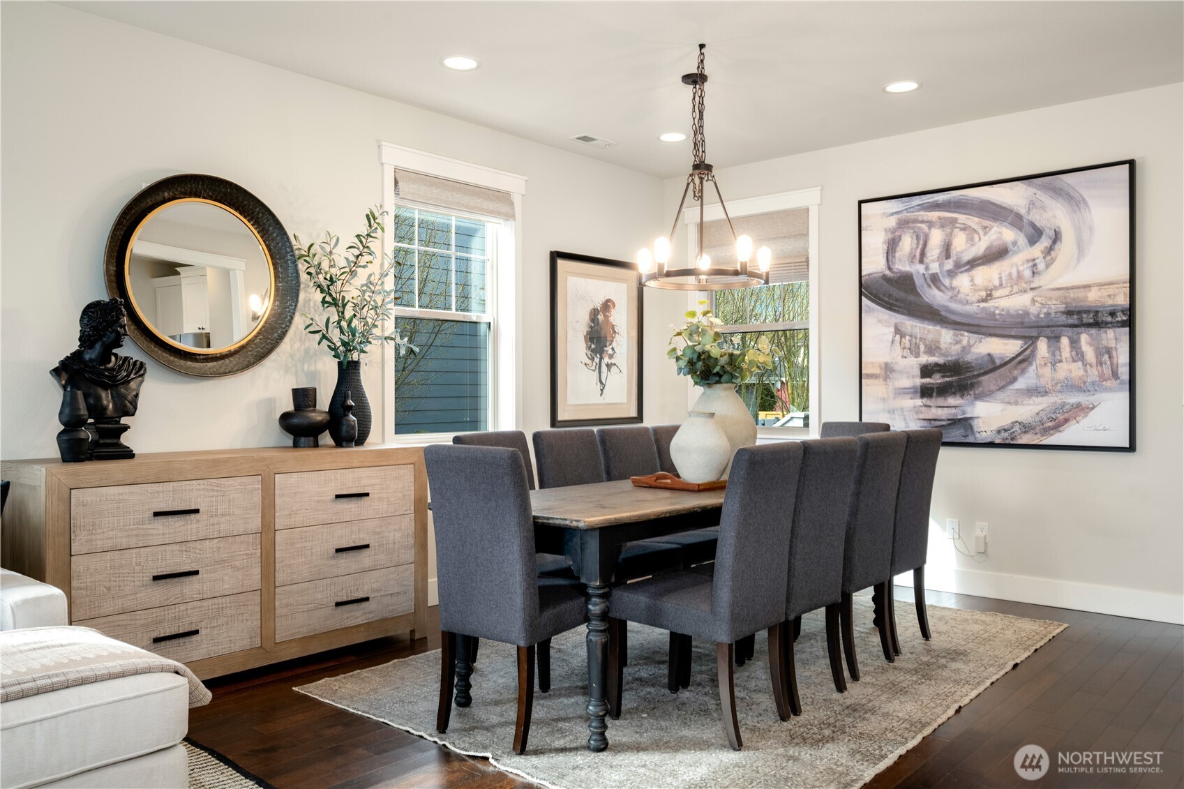 7709 17th Avenue Southwest Seattle, WA 98106 - Photo 9 of 37 a dining room with wooden floor a chandelier a wooden table and chairs