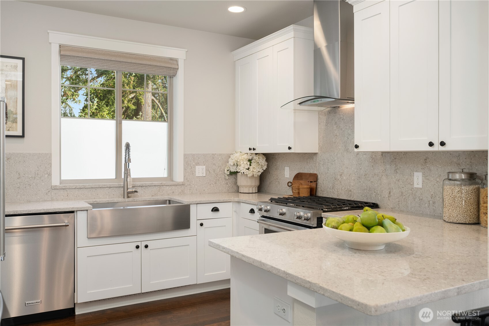 7709 17th Avenue Southwest Seattle, WA 98106 - Photo 10 of 37 a kitchen with stainless steel appliances white cabinets a stove a sink and a window