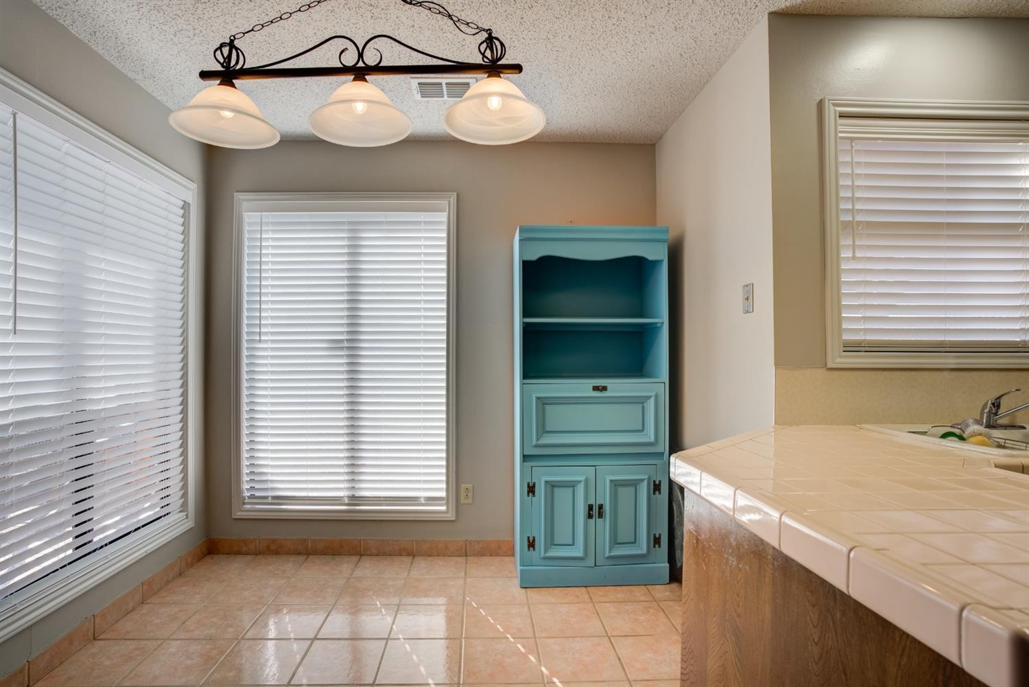 3409 103rd Street Lubbock, TX 79423 - Photo 8 of 33 a view of a kitchen with a sink cabinets and a window