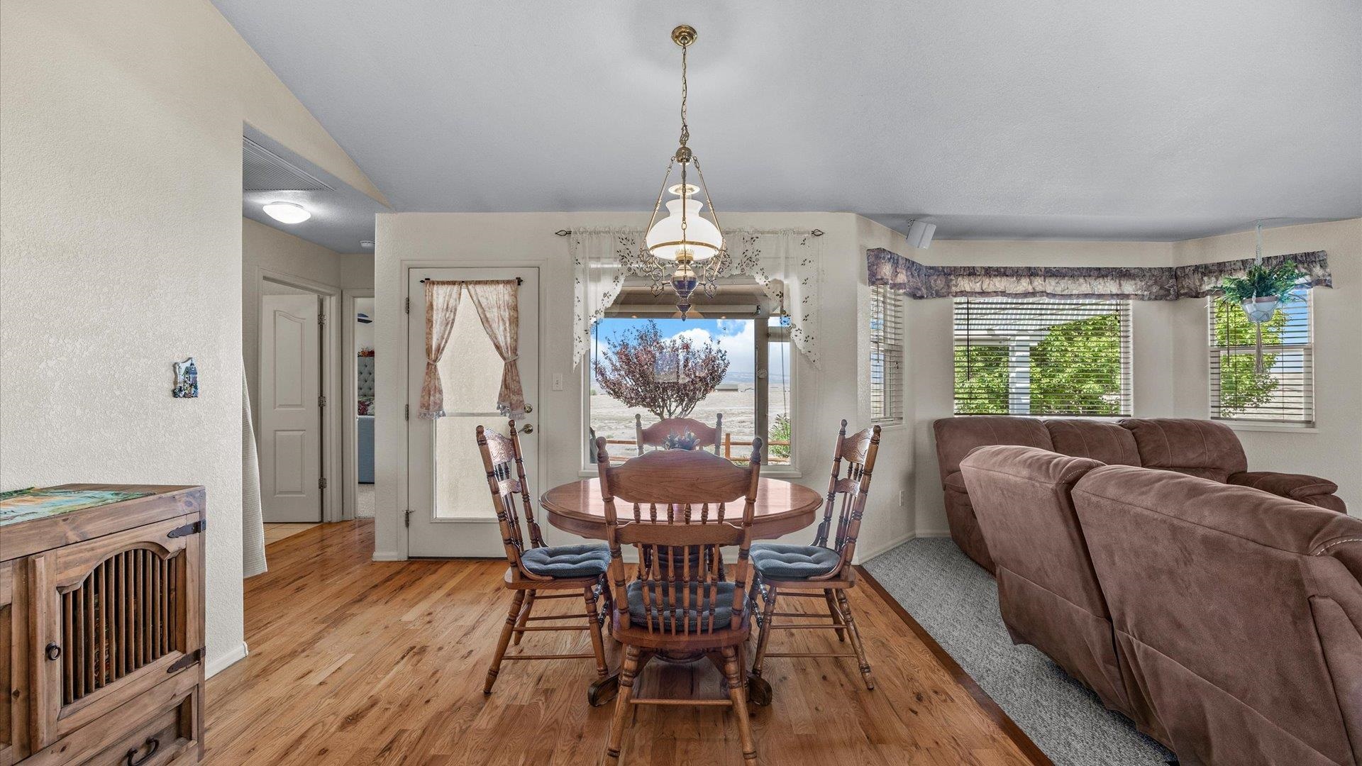 475 Los Broncos Road Whitewater, CO 81527 - Photo 12 of 41 a dining room with furniture a chandelier and wooden floor