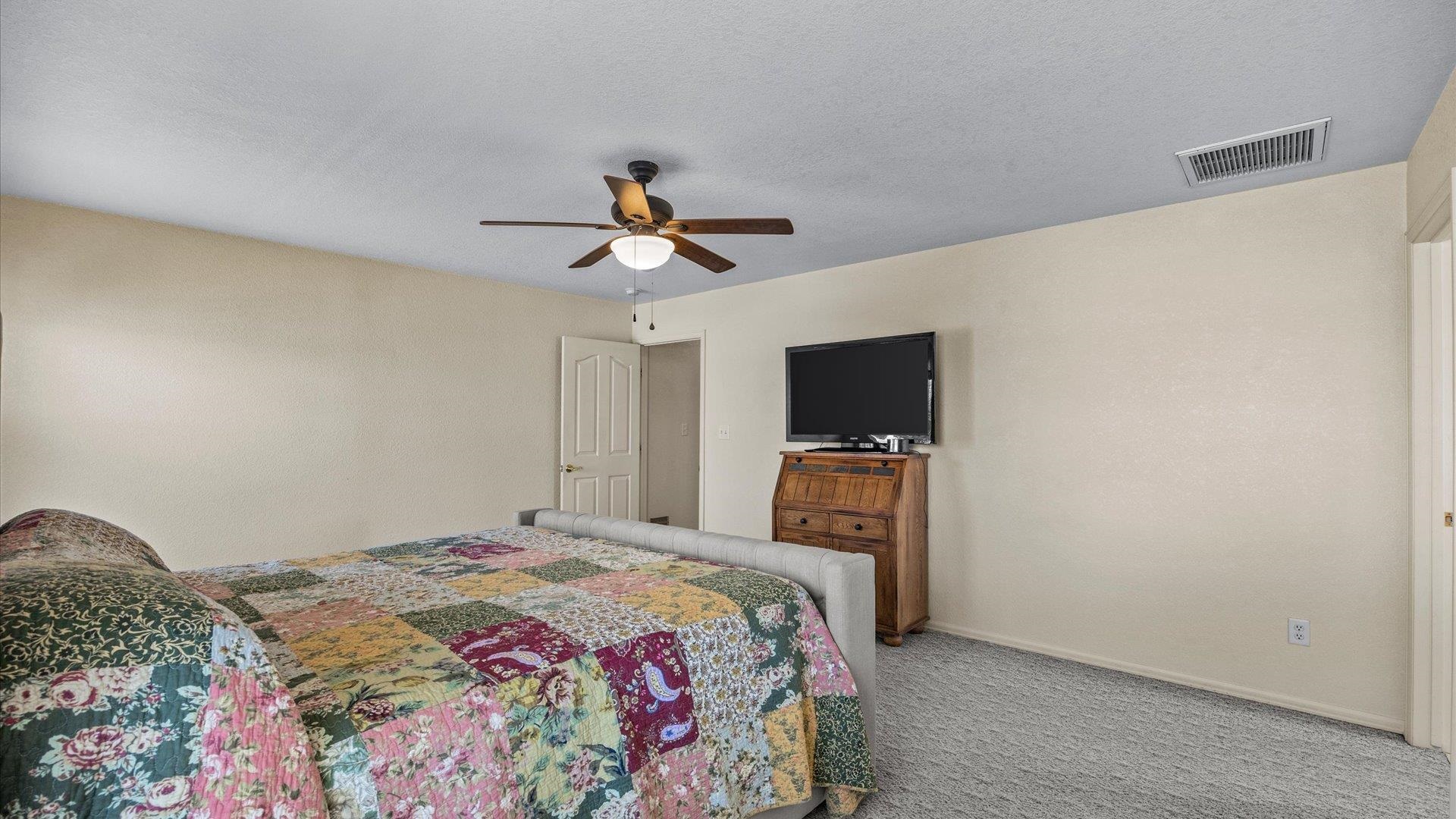 475 Los Broncos Road Whitewater, CO 81527 - Photo 15 of 41 a bedroom with a bed and a flat screen tv