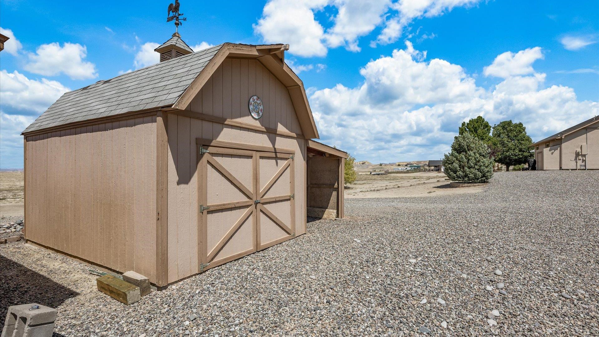 475 Los Broncos Road Whitewater, CO 81527 - Photo 31 of 41 a view of a grey house with a yard