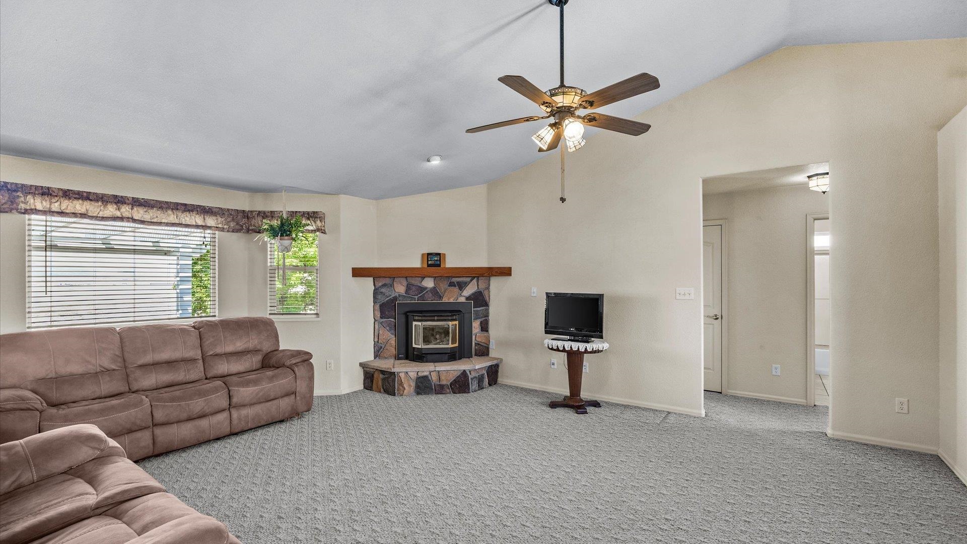 475 Los Broncos Road Whitewater, CO 81527 - Photo 8 of 41 a living room with furniture a fireplace and a window