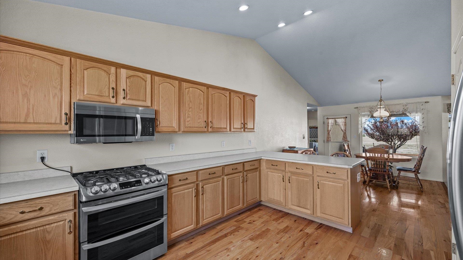 475 Los Broncos Road Whitewater, CO 81527 - Photo 9 of 41 a kitchen with stainless steel appliances a stove a sink cabinets and a wooden floor