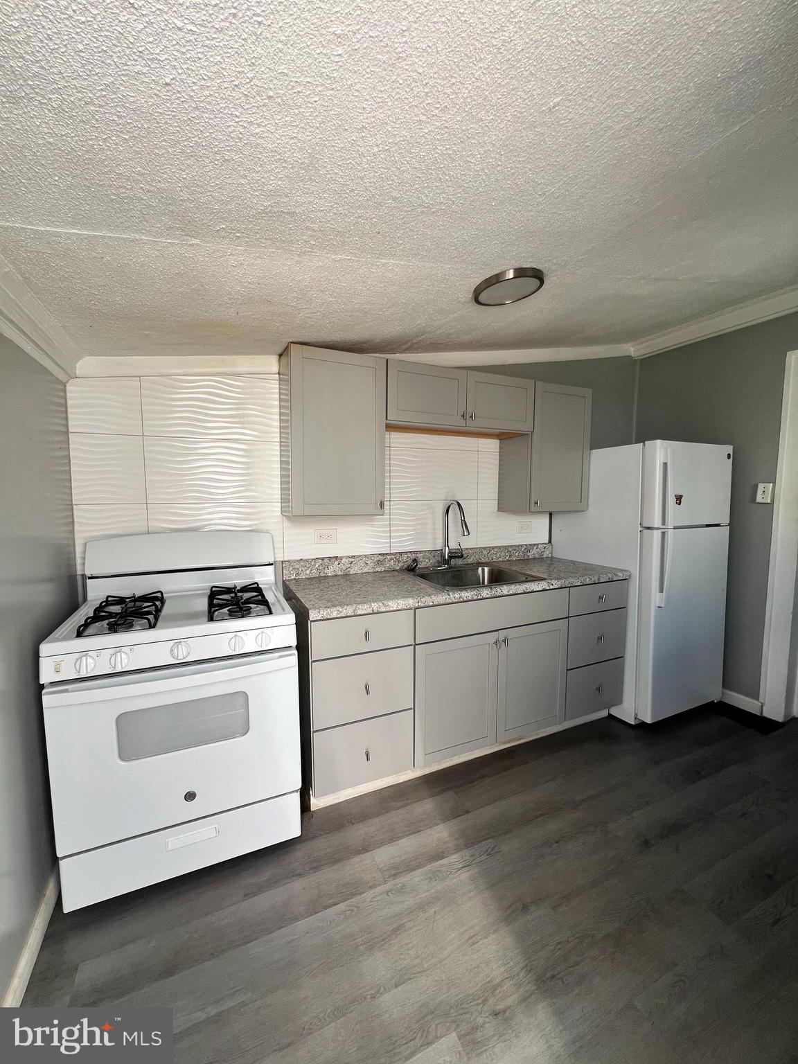 1264 Muhlenberg Street Reading, PA 19602 - Photo 3 of 16 a kitchen with appliances a stove and a refrigerator