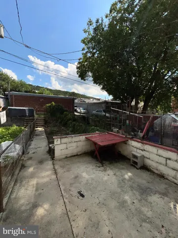 a view of backyard with barbeque grill and outdoor seating