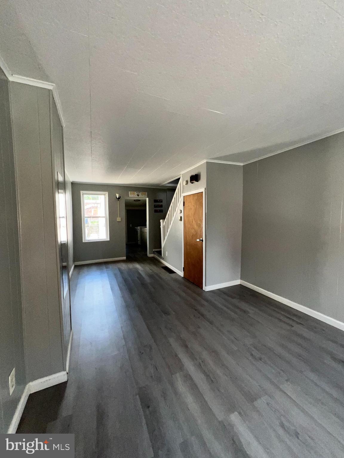 1264 Muhlenberg Street Reading, PA 19602 - Photo 9 of 16 a view of an empty room with wooden floor and a window