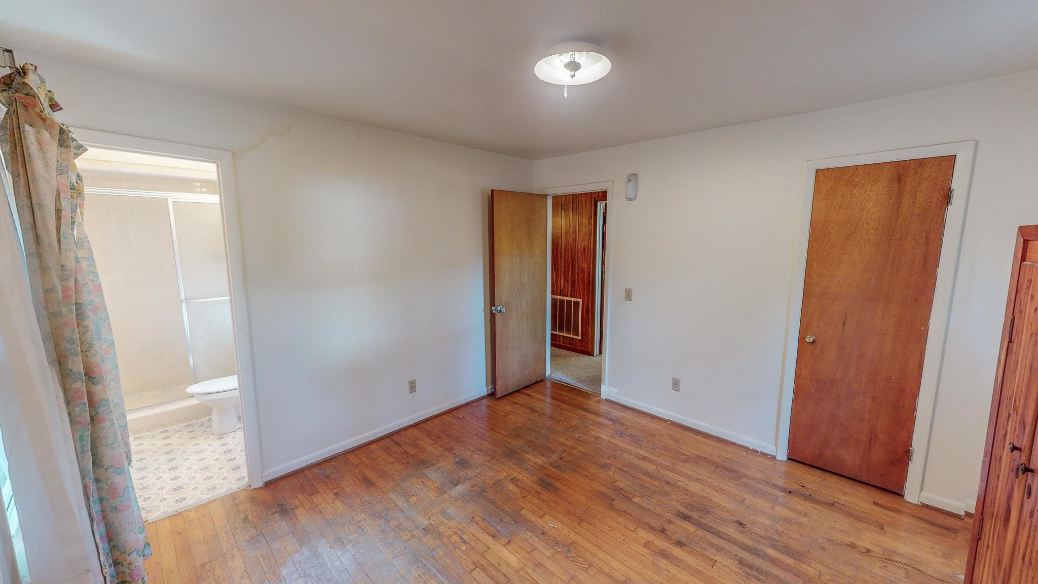 624 Frank Street Roxboro, NC 27573 - Photo 12 of 22 an empty room with wooden floor and closet area