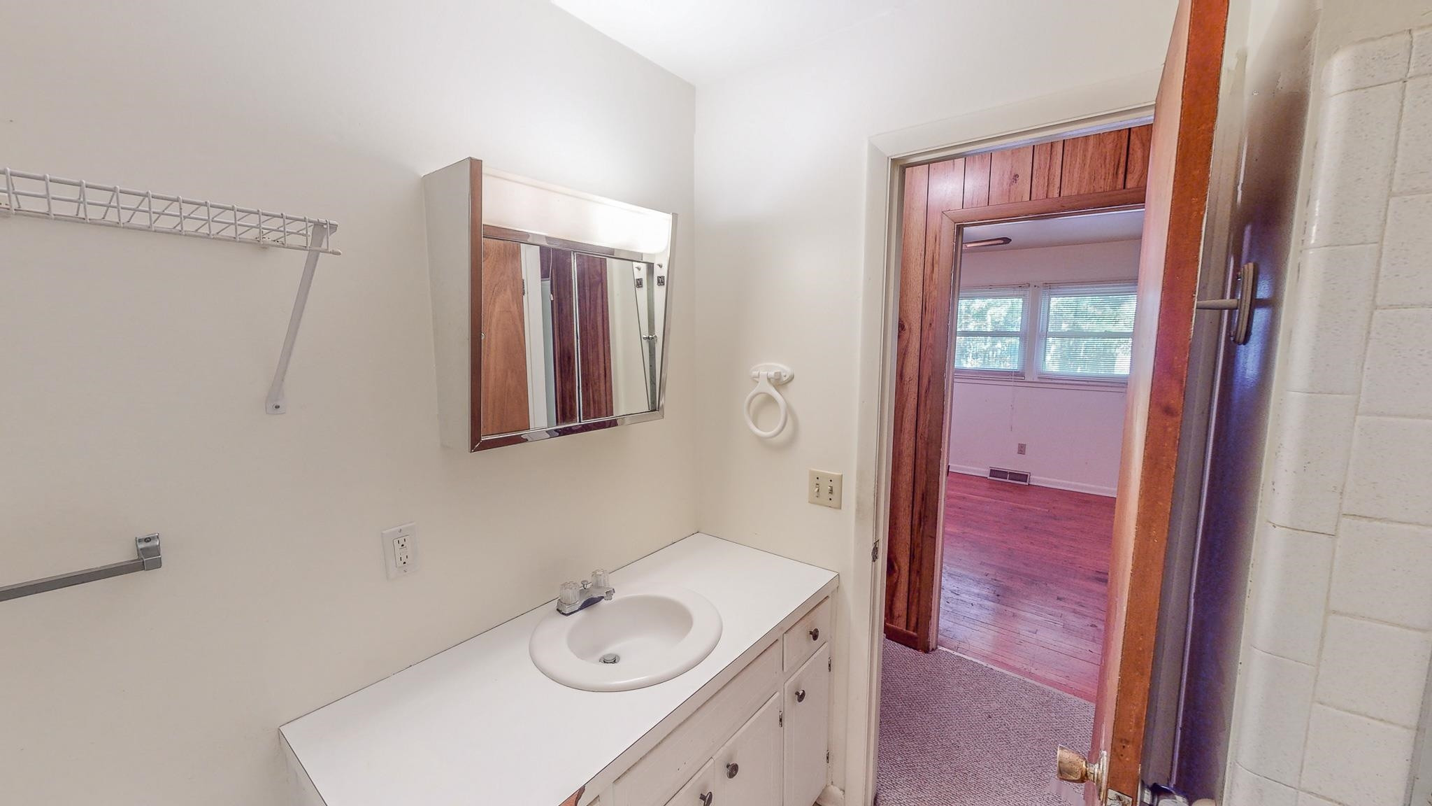 624 Frank Street Roxboro, NC 27573 - Photo 21 of 22 a bathroom with a sink a vanity and a mirror