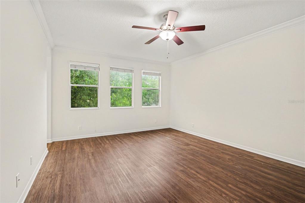 4819 Indian Deer Road Windermere, FL 34786 - Photo 13 of 30 an empty room with wooden floor ceiling fan and window