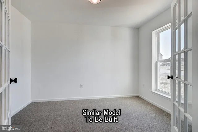 a view of a livingroom with wooden floor and window