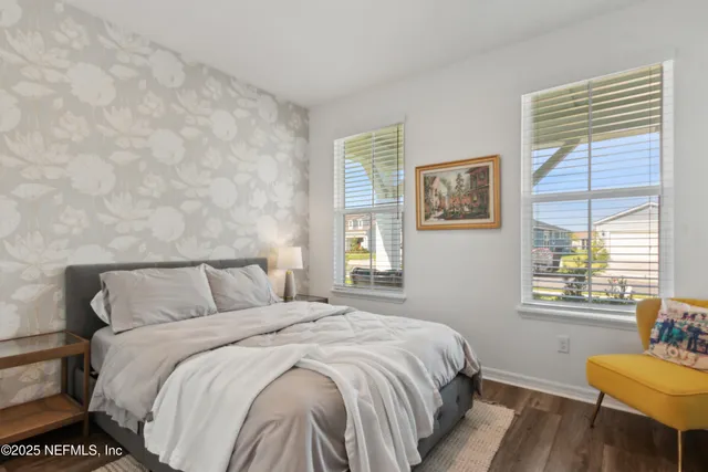 a view of swimming pool with outdoor seating and trees in the background