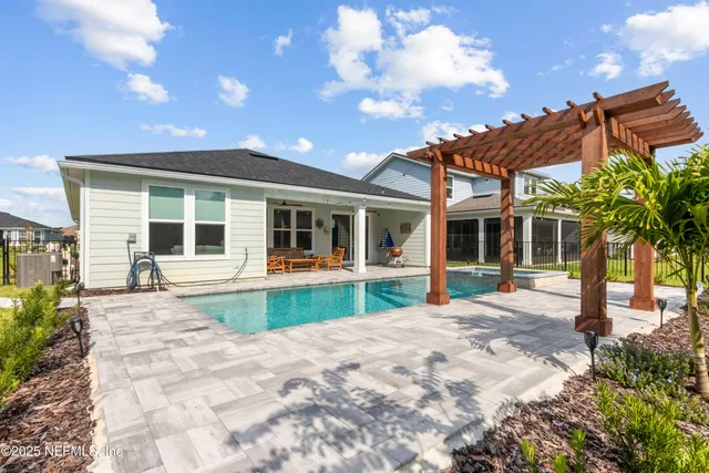 a view of swimming pool with a table and chairs
