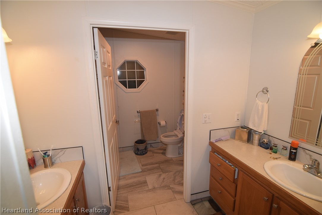 3124 White Oak Road Lorida, FL 33857 - Photo 15 of 34 a bathroom with a sink a toilet and mirror