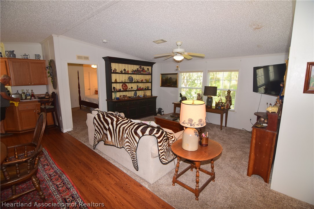 3124 White Oak Road Lorida, FL 33857 - Photo 22 of 34 a living room with furniture a flat screen tv and large window