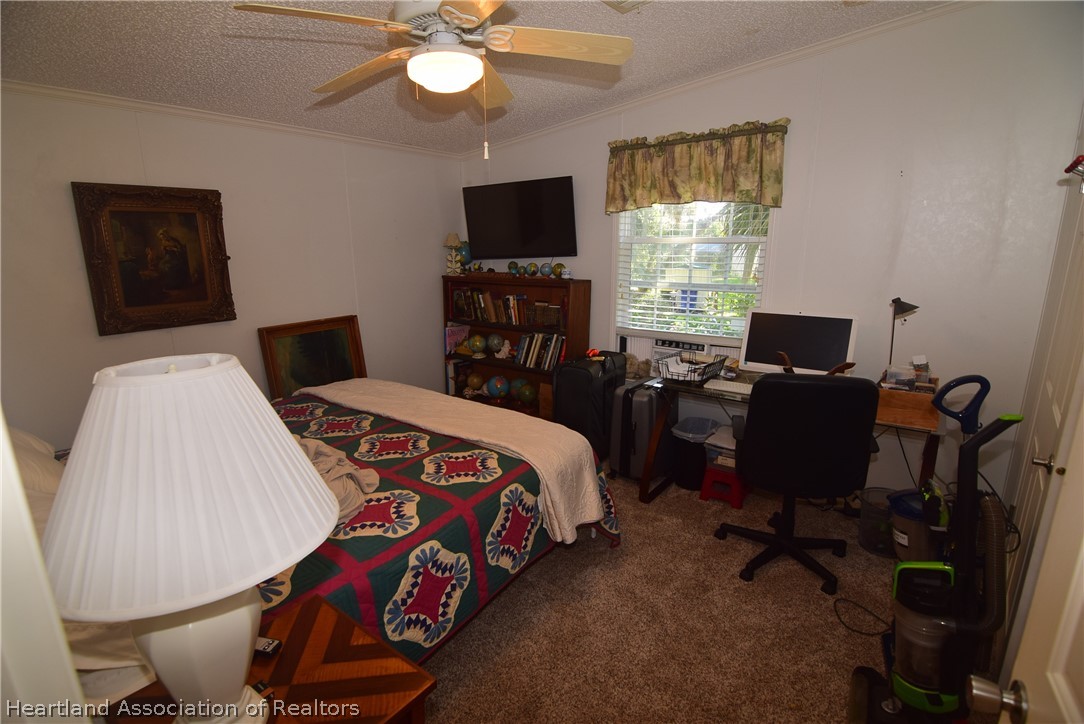 3124 White Oak Road Lorida, FL 33857 - Photo 23 of 34 a bedroom with bed tv and window