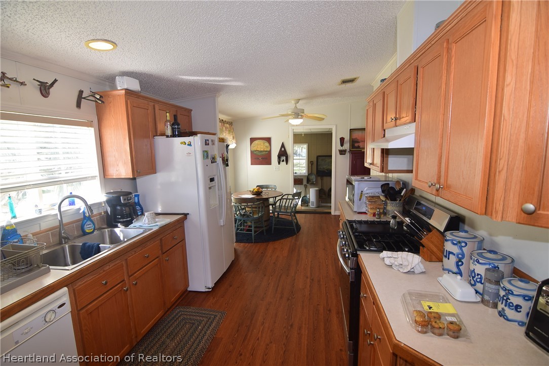 3124 White Oak Road Lorida, FL 33857 - Photo 29 of 34 a kitchen that has a lot of cabinets a sink and a refrigerator