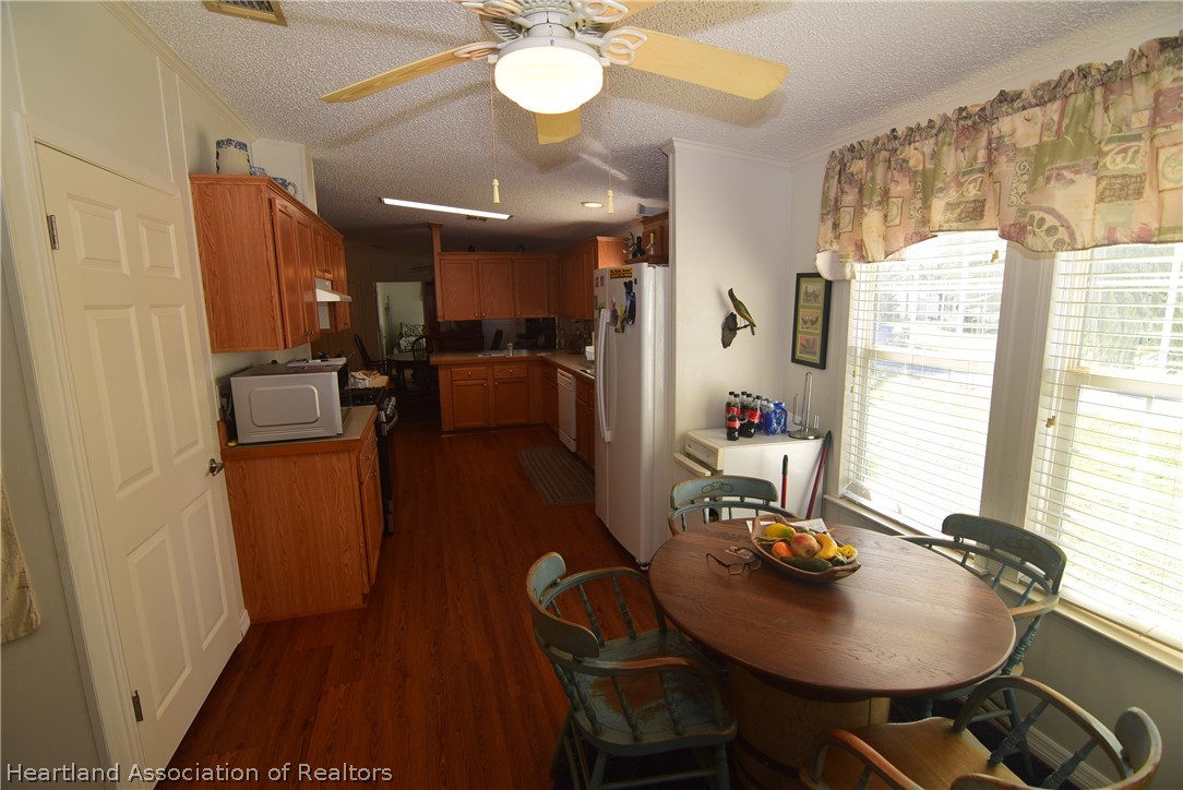 3124 White Oak Road Lorida, FL 33857 - Photo 9 of 34 a view of a dining room with furniture window and wooden floor