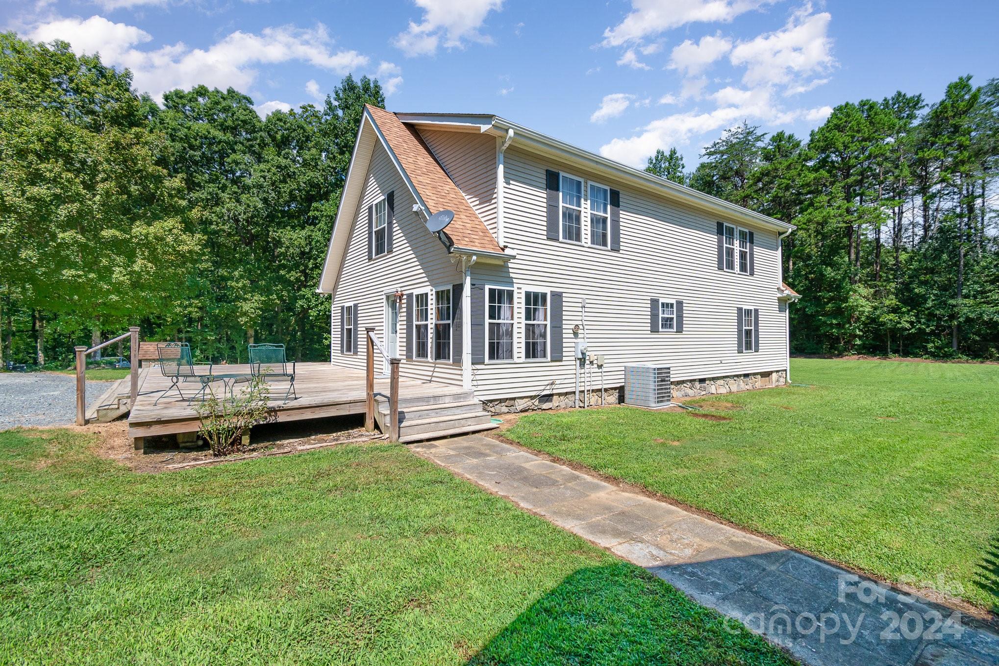 710 Rothrock Road Rockwell, NC 28138 - Photo 25 of 29 a view of a house with a backyard and a patio