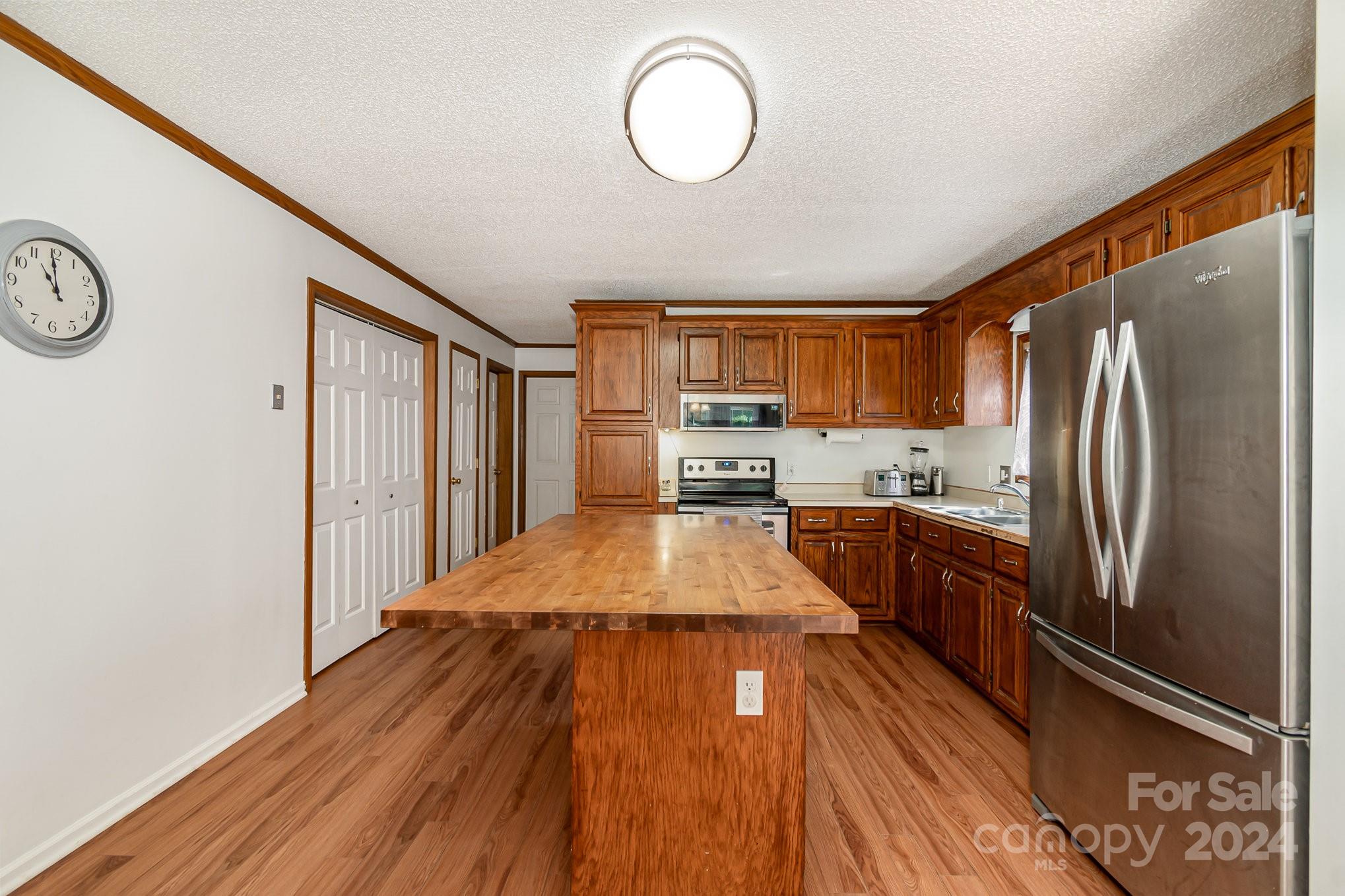 710 Rothrock Road Rockwell, NC 28138 - Photo 7 of 29 a kitchen with stainless steel appliances granite countertop a refrigerator a stove and a wooden floors