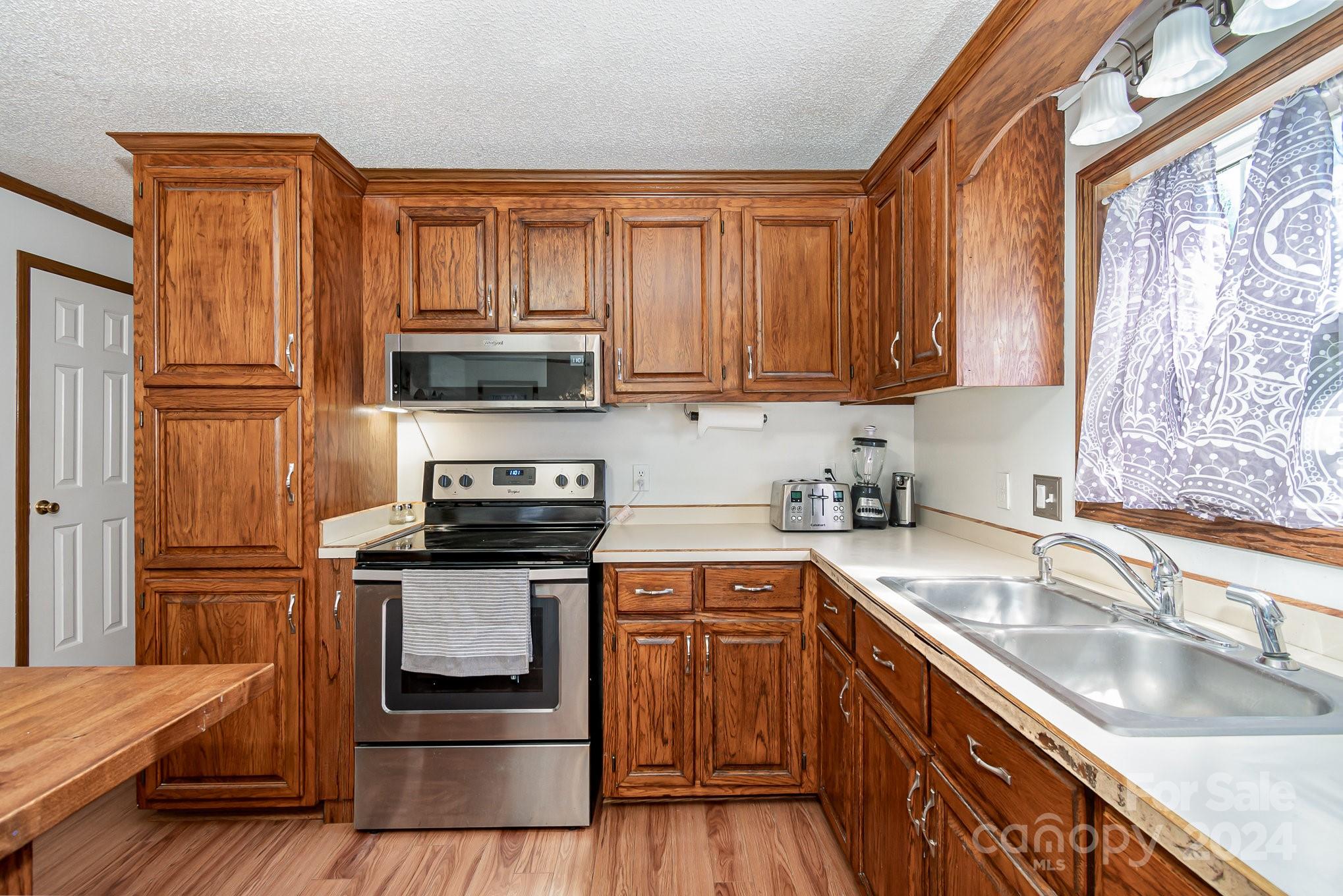 710 Rothrock Road Rockwell, NC 28138 - Photo 9 of 29 a kitchen with granite countertop a sink stove and cabinets
