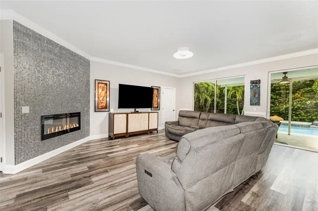a view of a dining room with furniture a rug and wooden floor