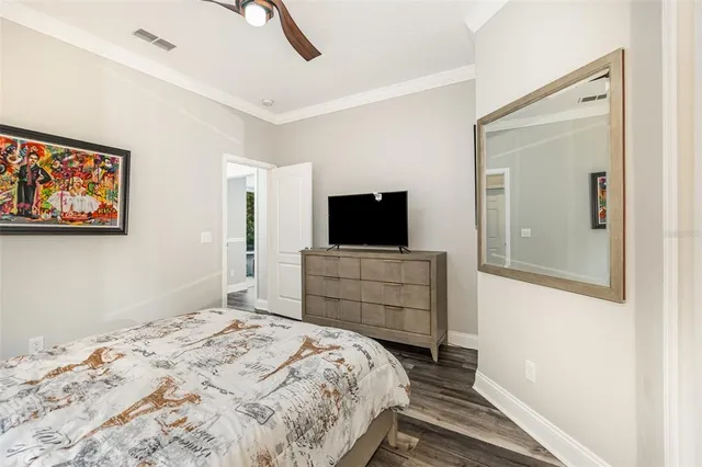 a bedroom with furniture and a flat screen tv