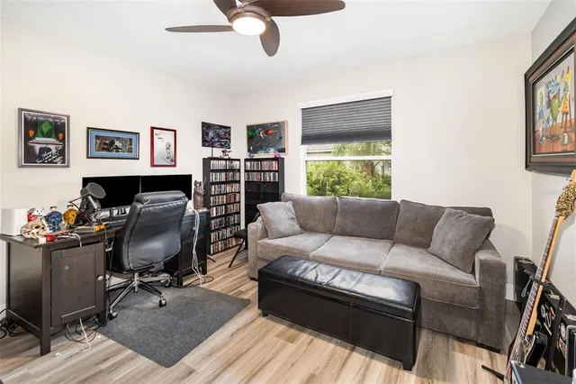 a bedroom with a bed and painting on the wall