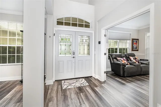 a view of a dining room with furniture wooden floor and chandelier