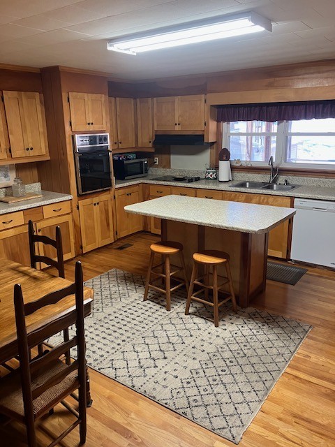 2442 Sherwood Road Sewanee, TN 37375 - Photo 2 of 11 a kitchen with stainless steel appliances kitchen island granite countertop a stove a sink and a microwave
