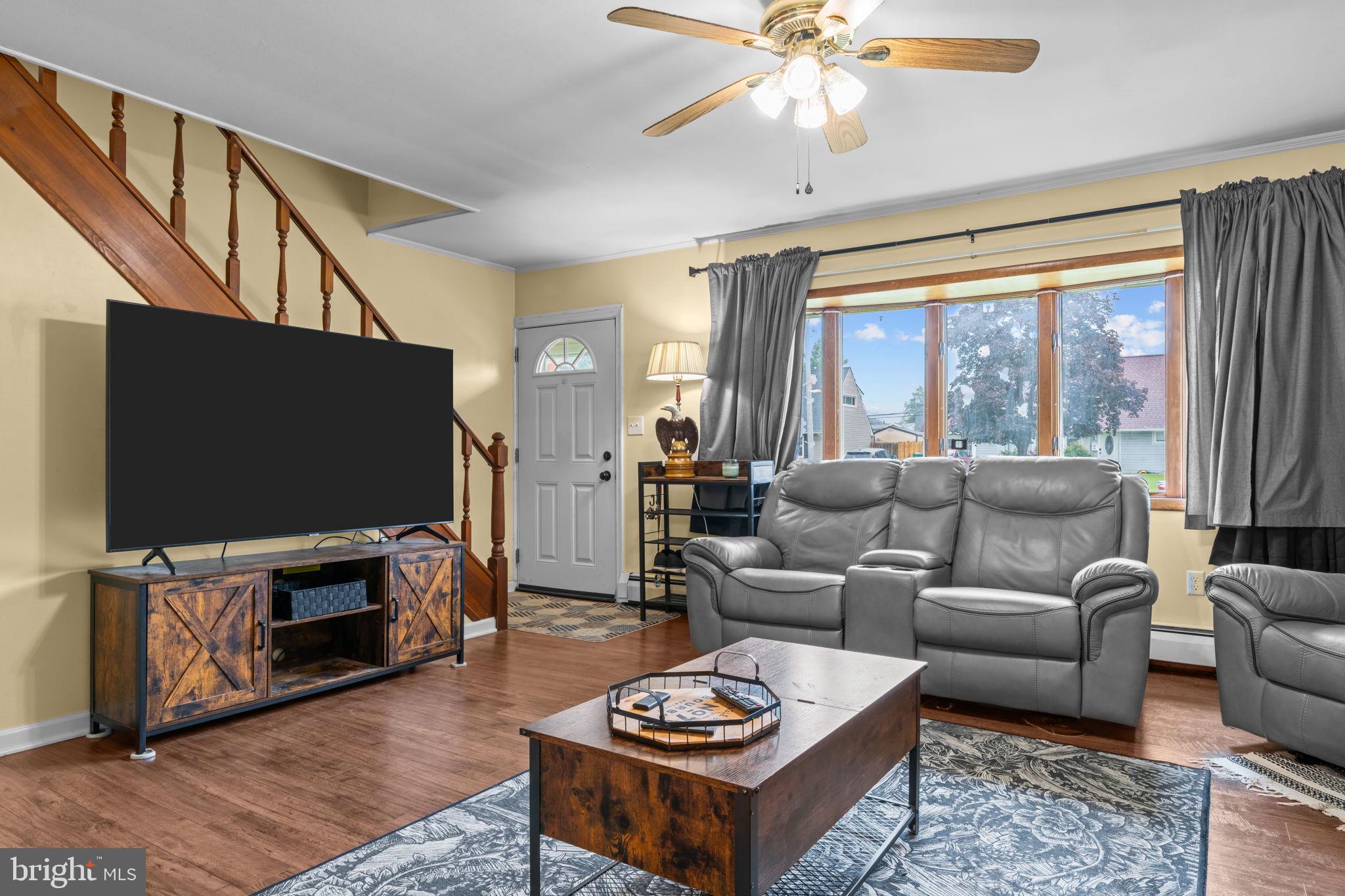 17 Middle Road Levittown, PA 19056 - Photo 4 of 22 a living room with furniture a flat screen tv and a large window