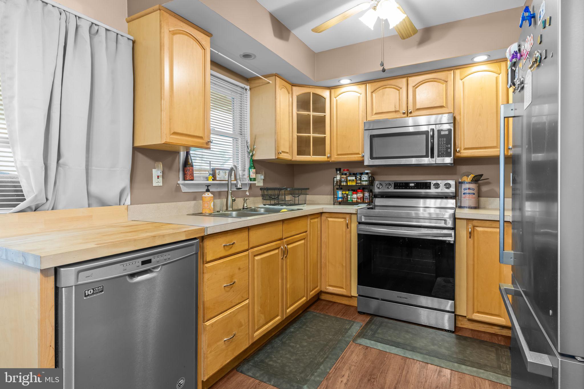 17 Middle Road Levittown, PA 19056 - Photo 7 of 22 a kitchen with stainless steel appliances a stove sink and microwave