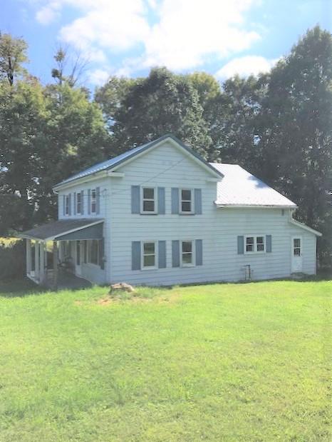 797 Wallacevile Road Titusville, PA 16354 - Photo 1 of 10 a front view of house with yard and trees in the background