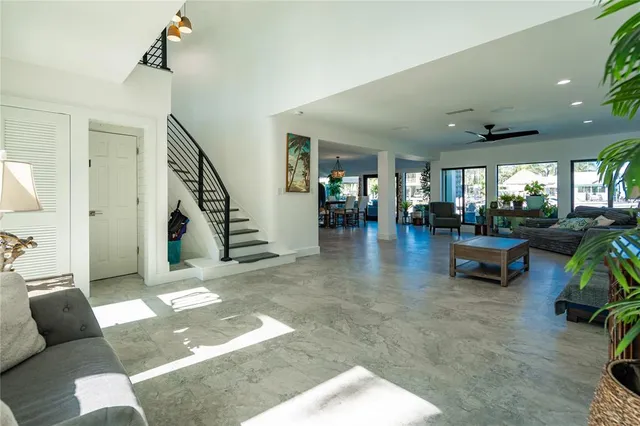 a view of a dining room and livingroom with furniture wooden floor a chandelier