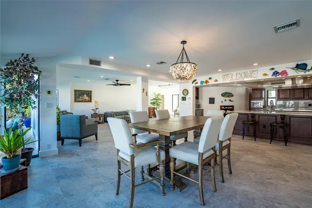 a living room with furniture floor to ceiling window and a fireplace