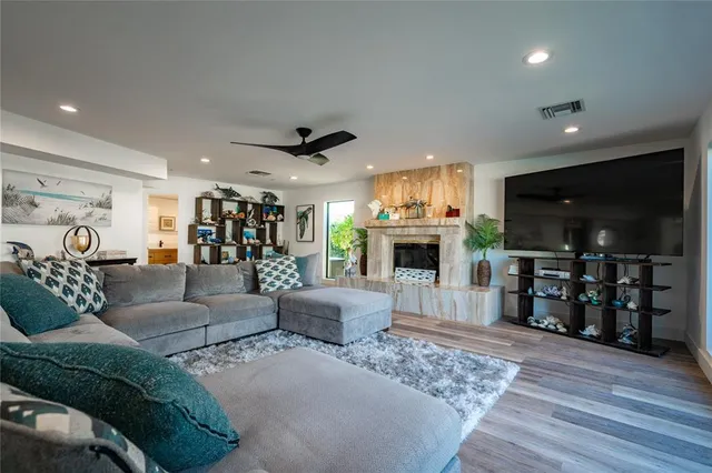 a living room with furniture and a floor to ceiling window