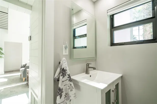 a spacious bathroom with a granite countertop sink mirror vanity and toilet