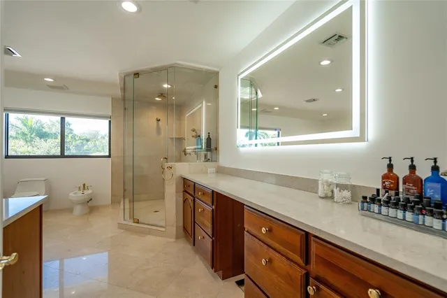 a bedroom with a bed and a dresser next to a window