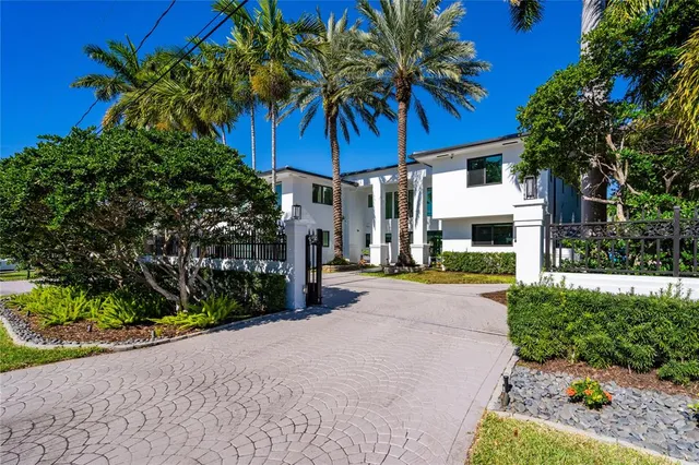 a view of a palm trees front of house