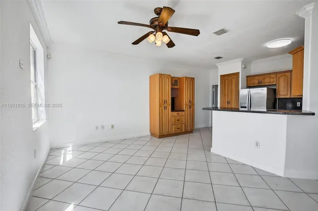 a kitchen with kitchen island granite countertop appliances cabinets and a sink