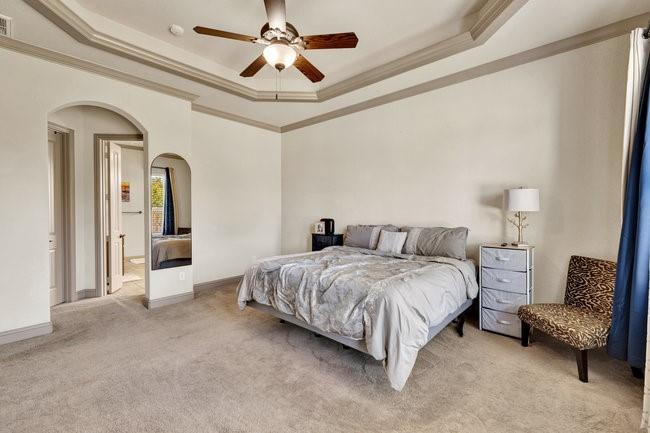 12901 Smokey Ranch Drive Fort Worth, TX 76052 - Photo 18 of 40 a spacious bedroom with a bed a couch and a chandelier