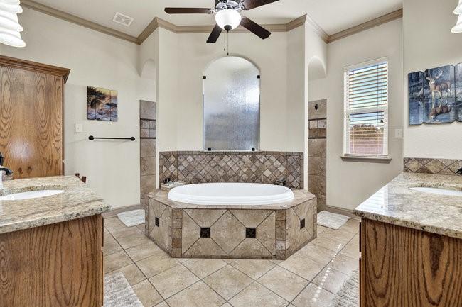 12901 Smokey Ranch Drive Fort Worth, TX 76052 - Photo 19 of 40 a bathroom with a granite countertop sink a toilet a mirror and shower