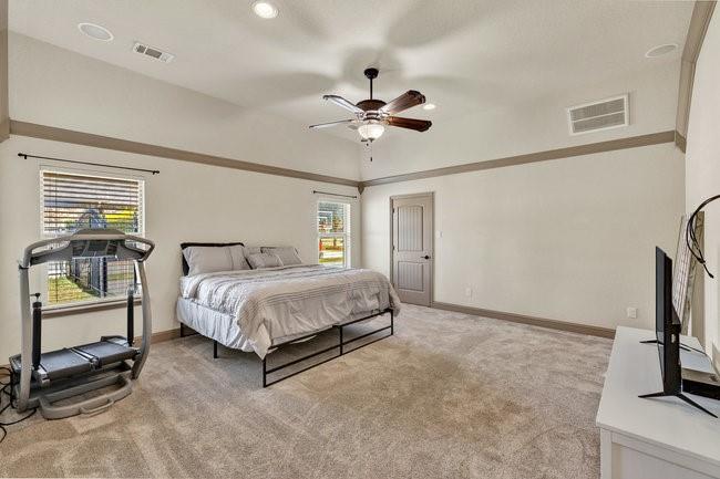 12901 Smokey Ranch Drive Fort Worth, TX 76052 - Photo 21 of 40 a spacious bedroom with a bed and a flat screen tv