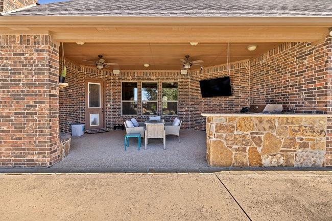 12901 Smokey Ranch Drive Fort Worth, TX 76052 - Photo 33 of 40 a living room with a couch and a flat screen tv