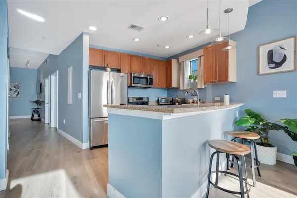 a kitchen with stainless steel appliances granite countertop a sink stove and cabinets