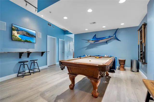 a living room with furniture pool table and a rug