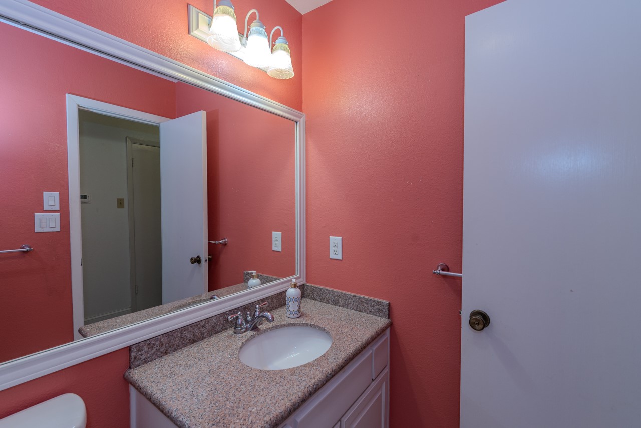 5975 Meadow Way Beaumont, TX 77707 - Photo 18 of 18 a bathroom with a sink and a mirror