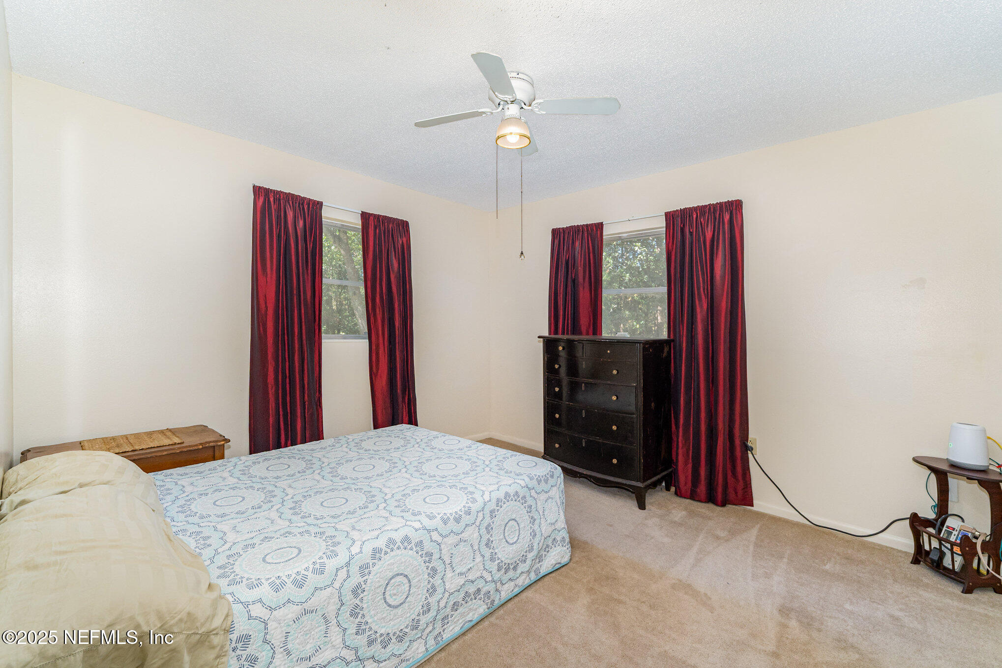1330 Northeast 157 Avenue Williston, FL 32696 - Photo 11 of 22 a bedroom with a bed and a chandelier
