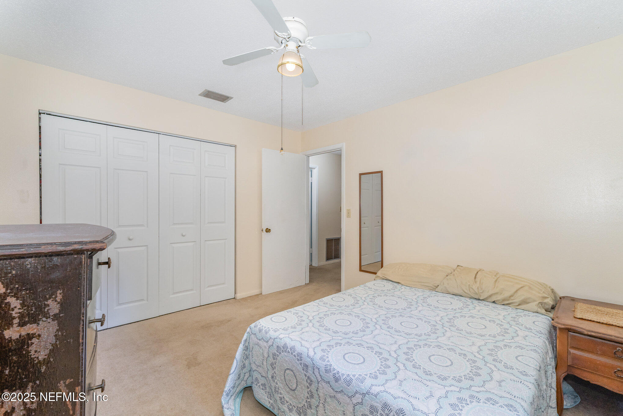 1330 Northeast 157 Avenue Williston, FL 32696 - Photo 12 of 22 a bedroom with a bed and a chandelier
